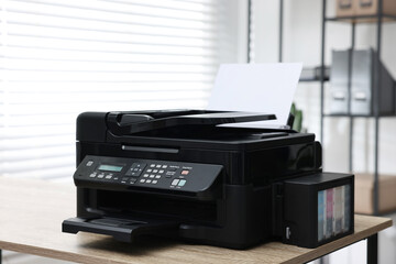 Modern printer with paper on table in office
