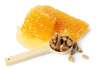 Sweet honeycombs and spoon with propolis granules isolated on white