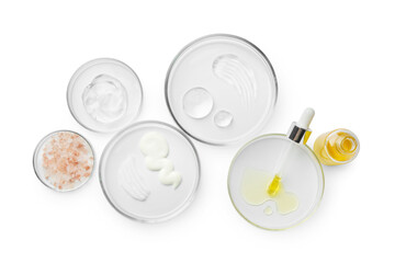Petri dishes with different cosmetic products isolated on white, flat lay