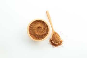 Superfood powder in bowl and spoon on white background, top view