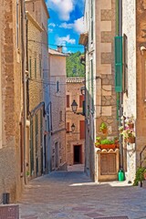 Image of a deserted street in a historic Spanish village at daytime