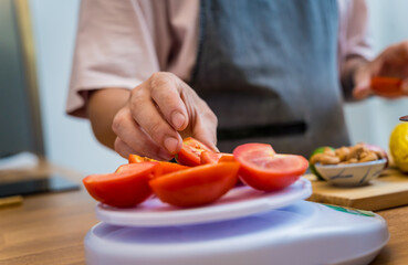 Chef at the kitchen preparing spicy glass noodle salad