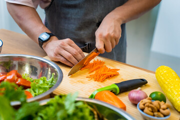 Chef at the kitchen preparing spicy glass noodle salad