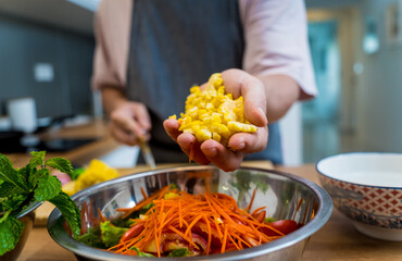Chef at the kitchen preparing spicy glass noodle salad