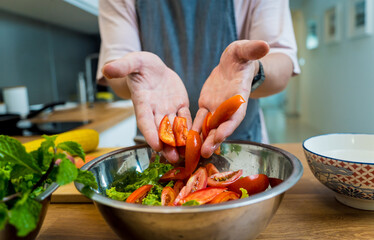 Chef at the kitchen preparing spicy glass noodle salad