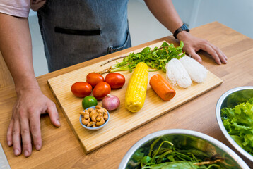Chef at the kitchen preparing spicy glass noodle salad