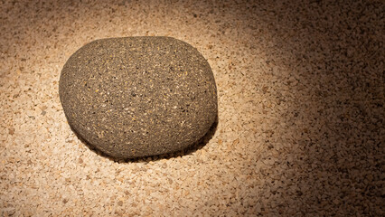 Grey granite stone on small white gravel in a minimalist Japanese garden