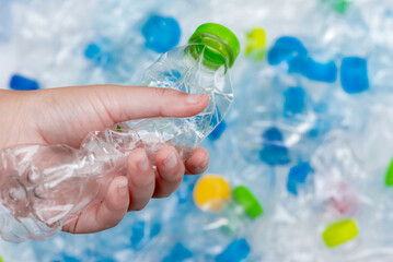 Plastic bottles in black garbage bags waiting to be taken to recycle.