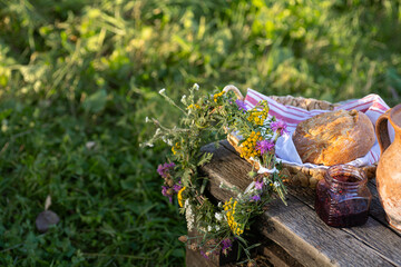 A Charming Rustic Picnic Setting Featuring Freshly Baked Goods and Beautiful Wildflowers