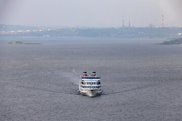 A four-deck passenger liner on the river. River landscape
