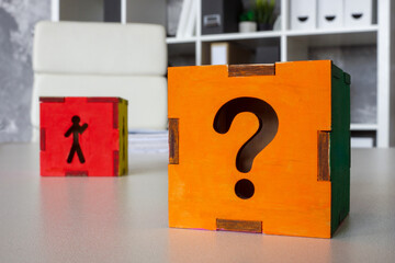 Cube with a question mark and a figure of a candidate, symbolizing uncertainty in hiring and...