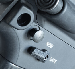 Rear takedown pin coming out of an assault rifle