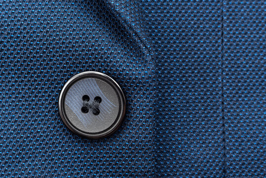 Close-up of a button on a men's blue suit. Button on a suit