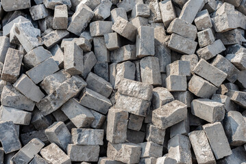 Background of gray whole and broken bricks. A pile of scattered bricks for a blind area