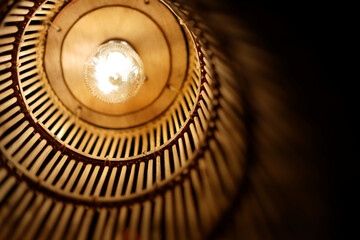 Ratten lantern light in dark interior dark space, close up. Cozy atmosphere in contemporary resort.