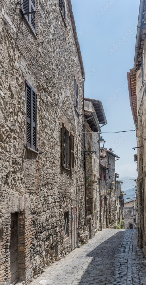 Wall mural picturesque old stone houses on downhill lane at medieval hilltop little town, narni, italy