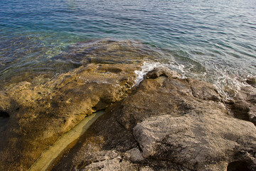 rocky Adriatic coastline with clear water in close-up