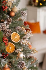 Christmas tree decorated with dried orange slices, dry berries, cones, pampas grass, paper ornaments, paper honeycombs