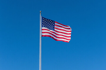 Fototapeta premium A large American flag is flying high in the sky