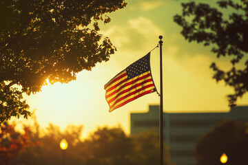 A large American flag is flying in the air in front of a building