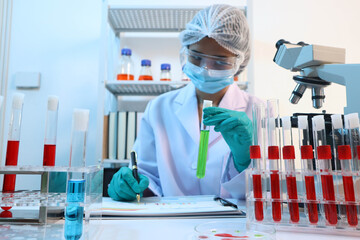 Scientists are testing medical drugs on a lab table.