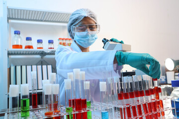 Scientists are testing medical drugs on a lab table.