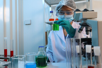Scientists are testing medical drugs on a lab table.