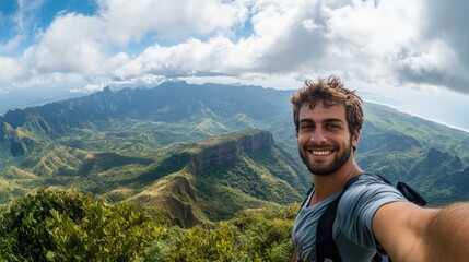Fototapeta premium A man poses for a selfie with a stunning vista behind him, blending his happiness with nature's beauty.