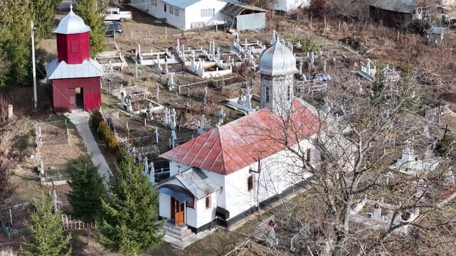 Landscape of an ld village in the mountains with church and cemetery,  Goicel, Buzau, Romania