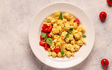 Sacсhettini pasta in a plate with tomato sauce.