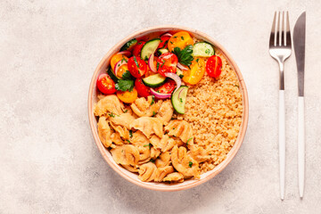 Bowl of quinoa with vegan soy meat and vegetables.