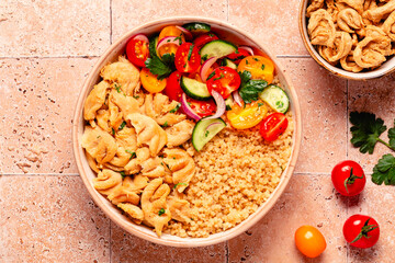Bowl of quinoa with vegan soy meat and vegetables.