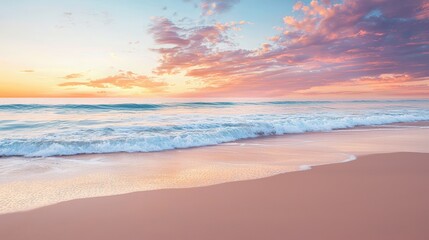 Obraz premium A tranquil beach at sunset, with waves gently lapping the shore and vibrant colors in the sky