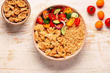Bowl of quinoa with vegan soy meat and vegetables.