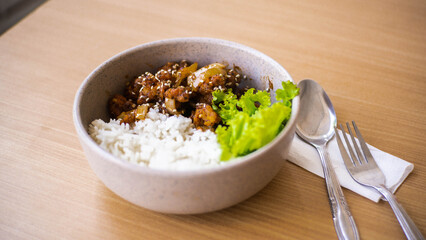 Ricebowl Beef Barbeque in a white bowl on a natural wood color table
