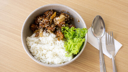 Ricebowl Beef Barbeque in a white bowl on a natural wood color table