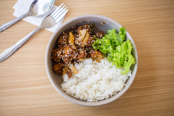 Ricebowl Beef Barbeque in a white bowl on a natural wood color table