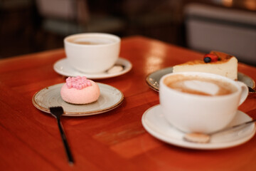 Cup with coffee and dessert on background