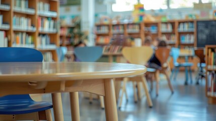 Close up of children's school chairs in the background of a blurry classroom with colorful tables and bookshelves