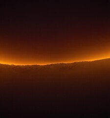 Obraz premium plane flying over mountain range at sunset