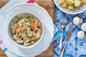 Pork in creamy mushroom sauce with boiled baby potatoes