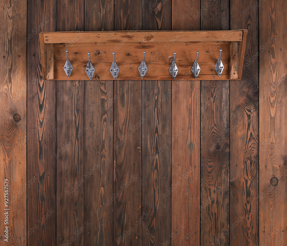 Wall mural wooden hanger with hooks on old wooden wall