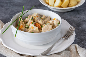 Pork in creamy mushroom sauce with boiled baby potatoes