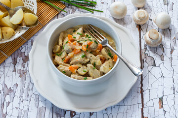 Pork in creamy mushroom sauce with boiled baby potatoes