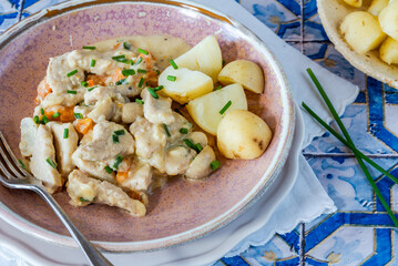 Pork in creamy mushroom sauce with boiled baby potatoes