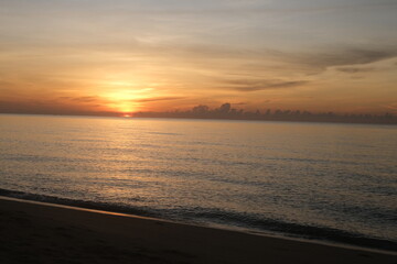 The sun rises at the sea in the morning.