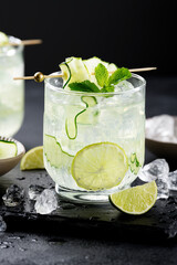 Cucumber margarita with lime and fresh mint, refreshing  cocktail. black background