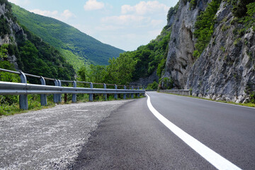 Picturesque view of rocky cliff and asphalt road in mountains