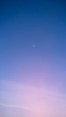 The crescent moon in the twilight sky