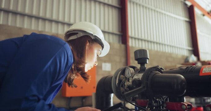 Woman, inspection and machine check or smartphone, mechanical engineer and maintenance or repairs. .Female person, inspector and project management in factory, warehouse and technician or technology